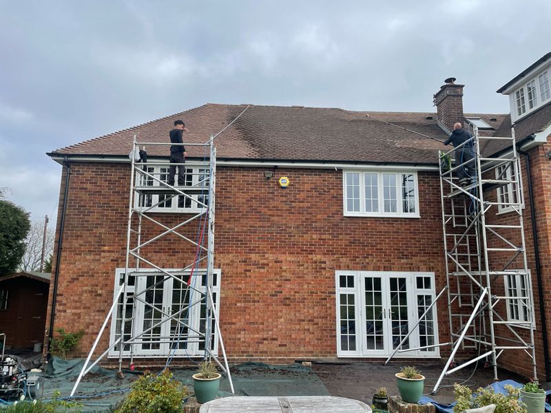 Roof cleaning carried out safely from scaffold towers by The Roof Moss Cleaners in Warlingham